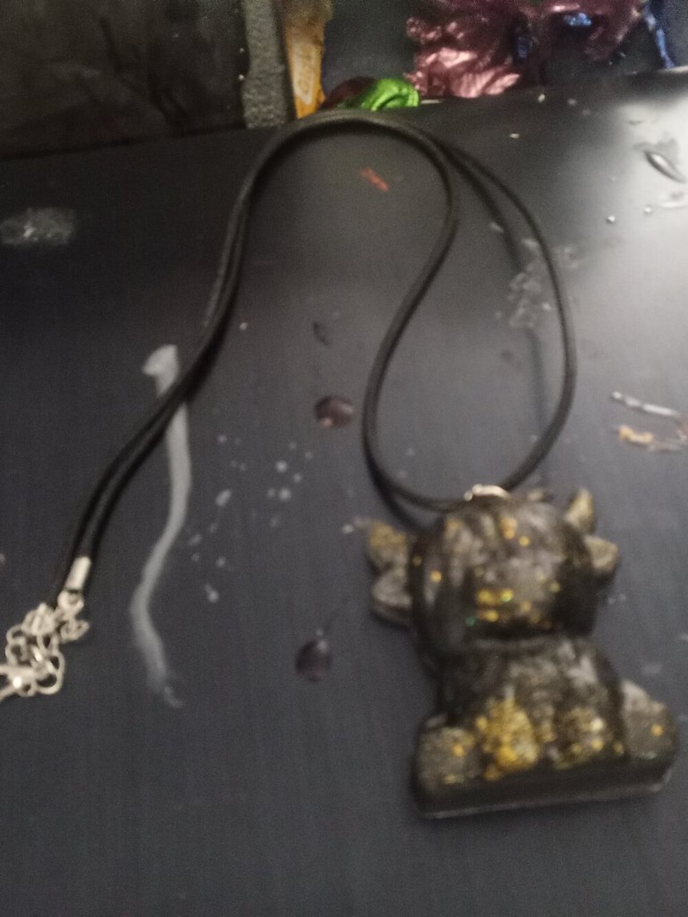 Handmade Black and Gold Highland Cow Resin necklace.